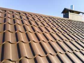 Closeup of house roof top covered with metallic shingles