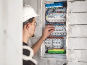 Electrical technician working in a switchboard with fuses. Installation and connection.