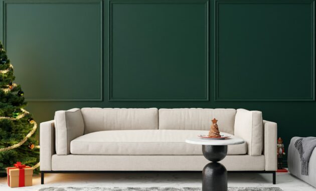 Empty green wall in modern living room with Christmas decoration. Mock up interior in classic style.