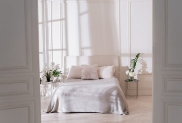 Light bedroom interior with morning sunlight