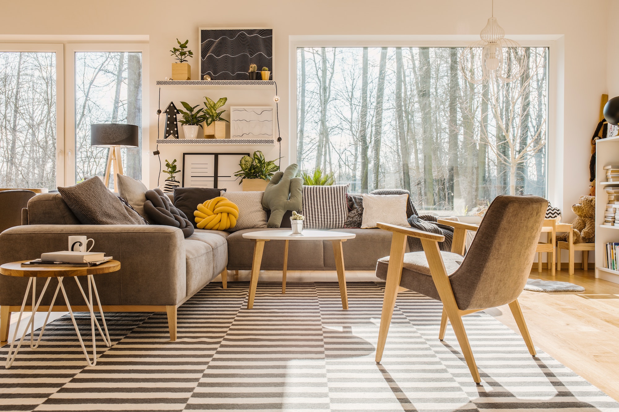 Low angle view of a scandinavian, sunlit living room interior wi