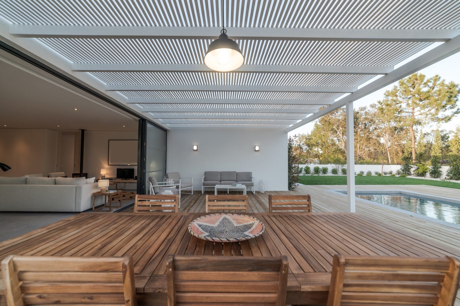 Modern house with garden swimming pool and wooden deck
