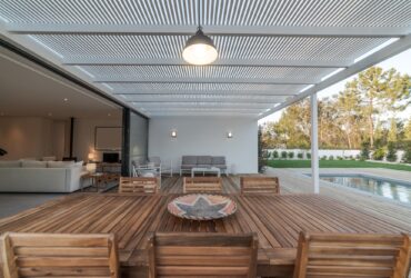 Modern house with garden swimming pool and wooden deck