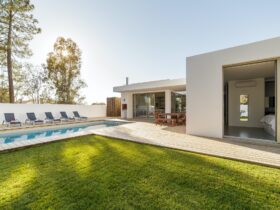Modern house with garden swimming pool and wooden deck