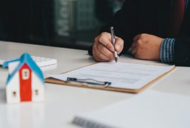 Real estate brokers sign contract paper. Real estate agent, property broker, real estate investment