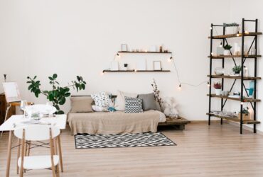Stylish scandinavian living room with furniture, plants. Modern decor of bright room