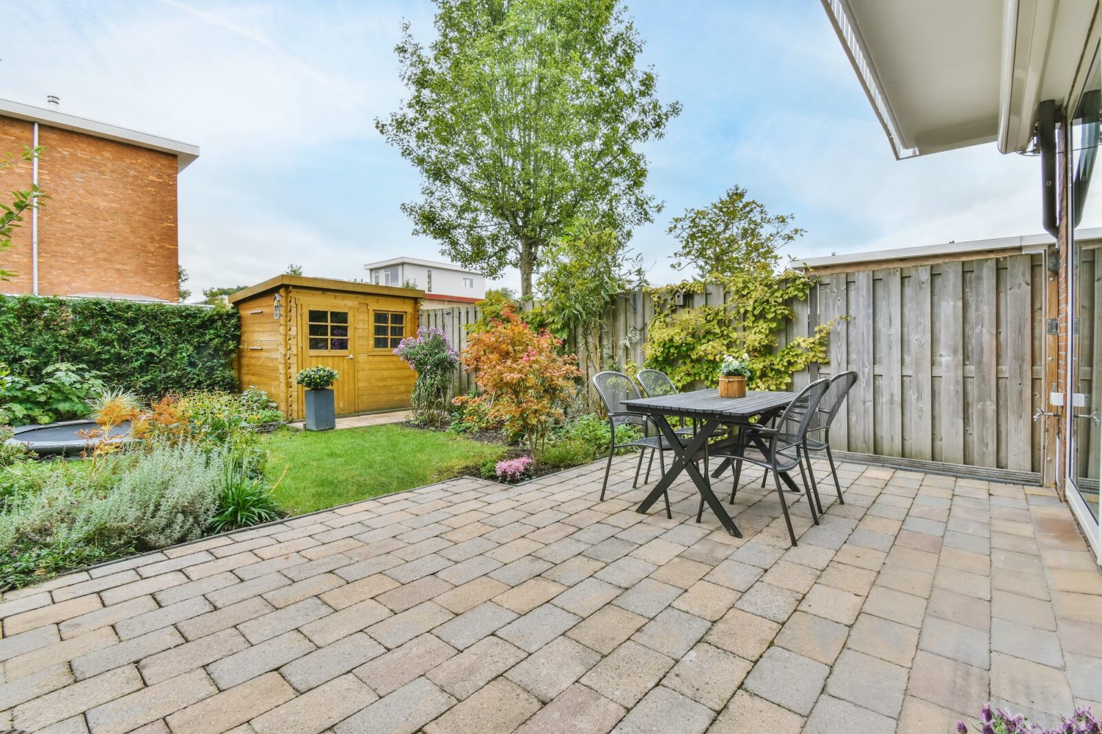 The backyard of a house with a summer dining room
