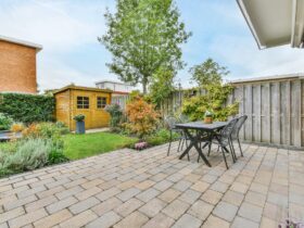 The backyard of a house with a summer dining room