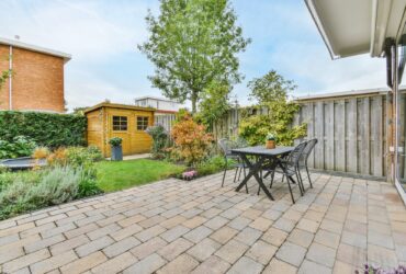 The backyard of a house with a summer dining room