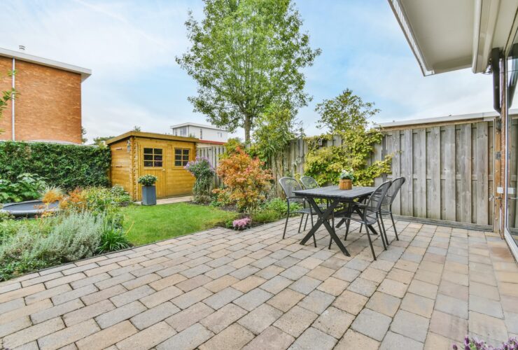 The backyard of a house with a summer dining room