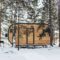 Wooden tiny house snowy winter forest. Glamping