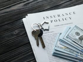 Home insurance policy with keys and dollar money mortgage, loan or home insurance documents