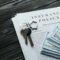 Home insurance policy with keys and dollar money mortgage, loan or home insurance documents