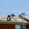 Home roof construction applying roof new shingles in apartment building