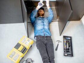 Man repairing kitchen plumbing