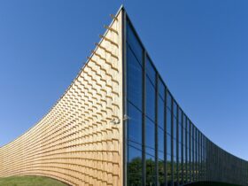 Modern university buildings, wooden beams projecting from a curved wood cladding