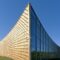 Modern university buildings, wooden beams projecting from a curved wood cladding