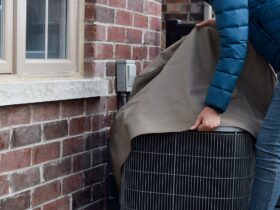 Putting cover on air conditioner unit