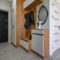 Small entrance hallway interior with shoe storage, hanger stand and mirror