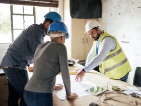 Construction workers, teamwork collaboration and blueprint planning in house, home or office buildi