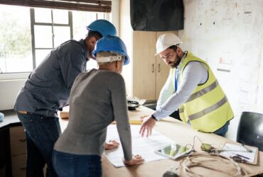Construction workers, teamwork collaboration and blueprint planning in house, home or office buildi