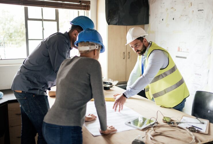 Construction workers, teamwork collaboration and blueprint planning in house, home or office buildi
