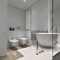 Modern Bathroom Interior in the Foreground there is a Marble Countertop Washbasin