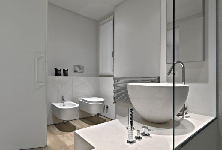 Modern Bathroom Interior in the Foreground there is a Marble Countertop Washbasin