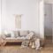 Sunlit living room interior with open door, herringbone parquet