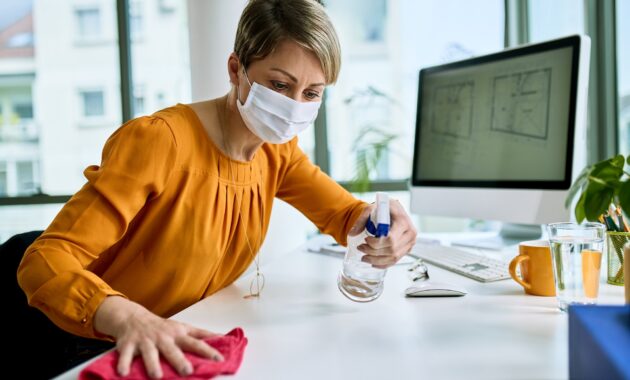 Disinfecting her workspace!