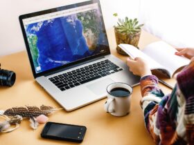 stylish girl with coffee on background of laptop map