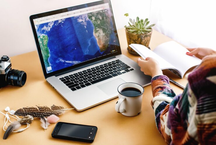 stylish girl with coffee on background of laptop map