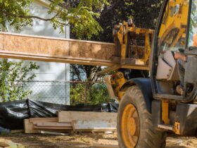 A construction worker installing silent floor joists in new construction forklift stacker loader
