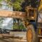 A construction worker installing silent floor joists in new construction forklift stacker loader