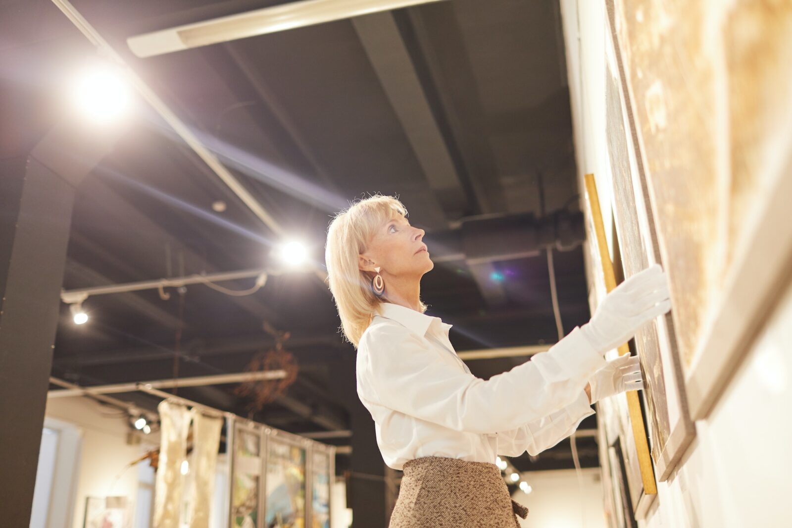 Art Gallery Manager Hanging Paintings
