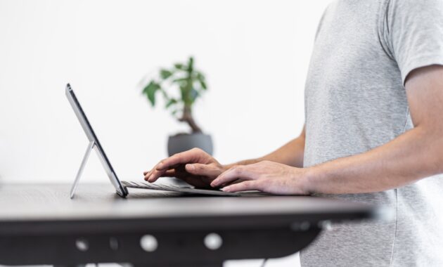 Asian man working at standing desk