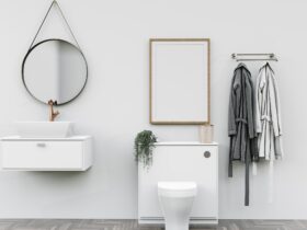 Bathroom with washbasin with bathrobes and wall mounted photo frame