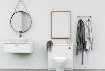 Bathroom with washbasin with bathrobes and wall mounted photo frame
