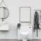 Bathroom with washbasin with bathrobes and wall mounted photo frame