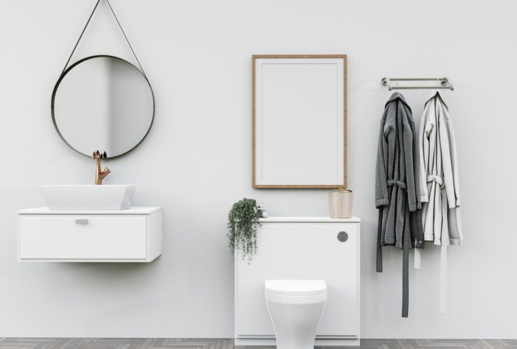 Bathroom with washbasin with bathrobes and wall mounted photo frame