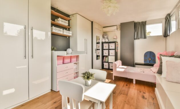 Chair and lamp near window in child room