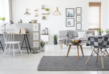 Checkered, stylish chair on a gray rug in a spacious, scandinavi