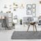 Checkered, stylish chair on a gray rug in a spacious, scandinavi