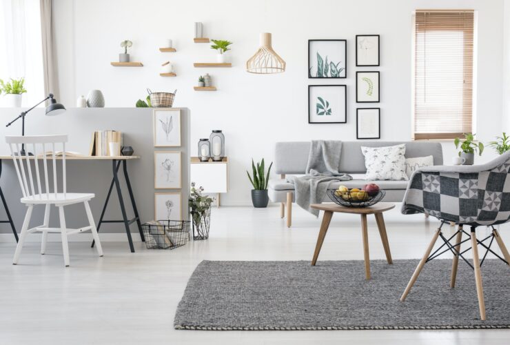 Checkered, stylish chair on a gray rug in a spacious, scandinavi
