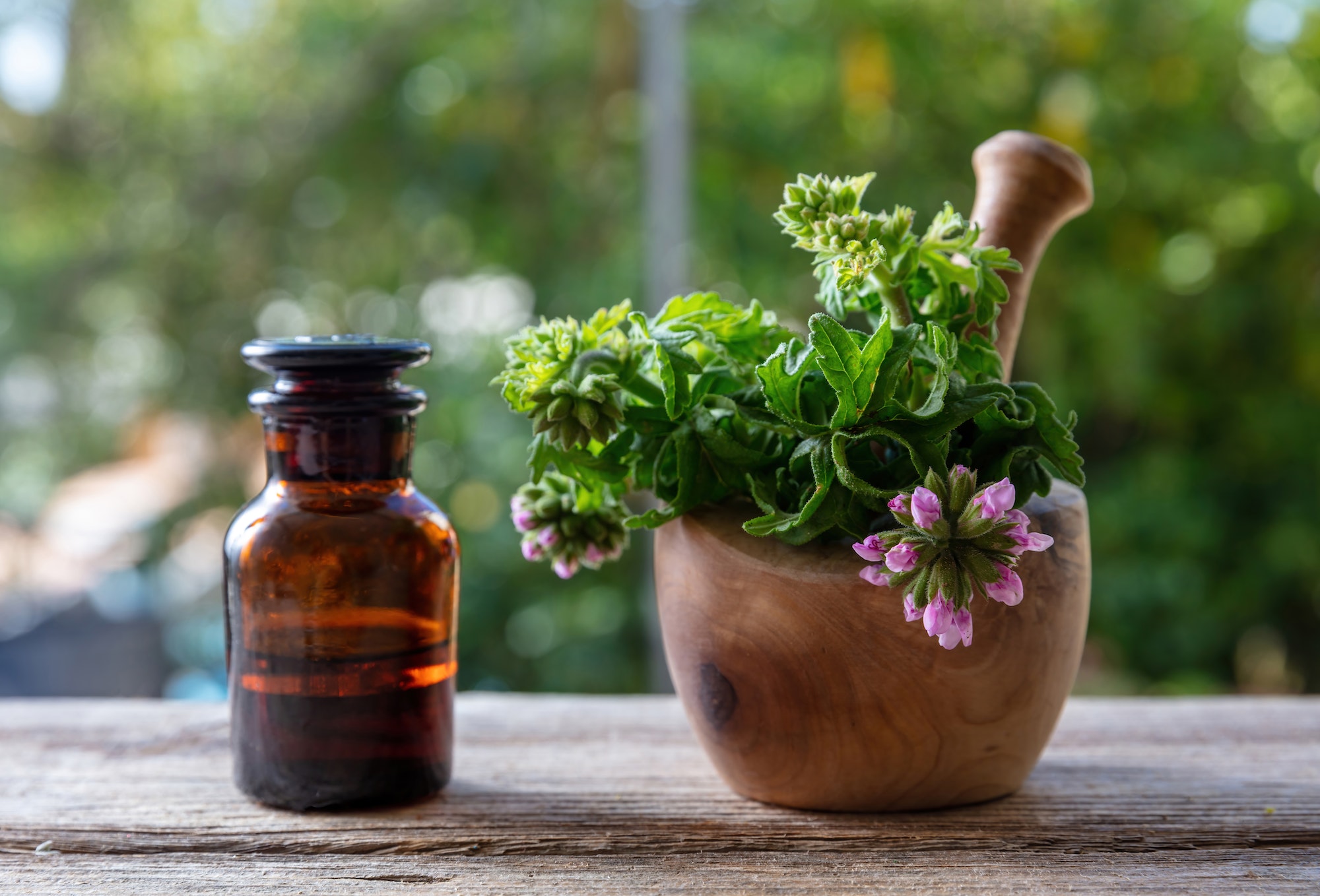 Citronella geranium essential oil on table, close up. Aromatherapy oil, mosquito repellent