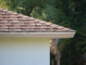 Closeup of house roof top covered with asphalt or bitumen shingles. Waterproofing of new building