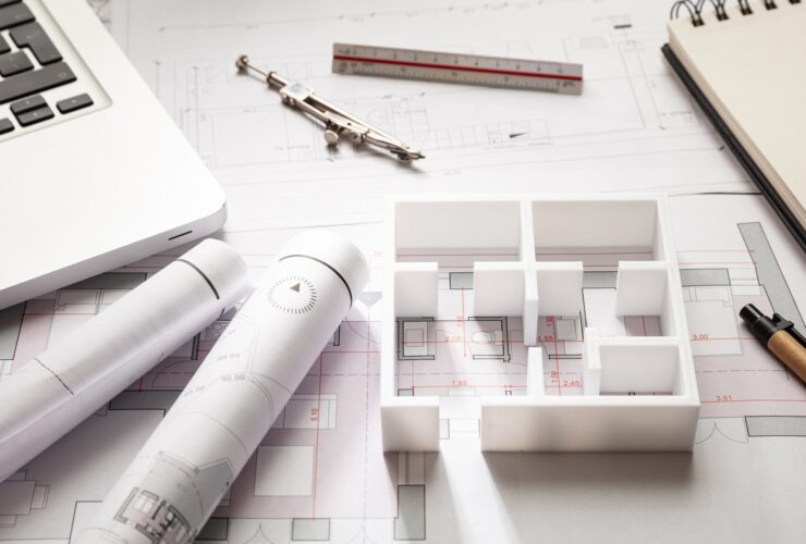 Construction concept. Residential building drawings and house model,