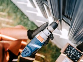 construction worker working with an electric screwdriver on the construction site