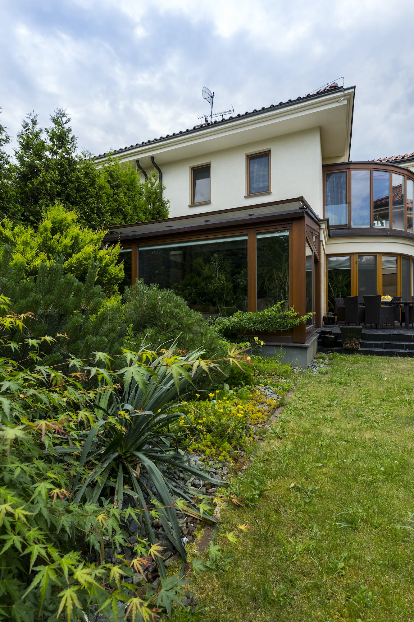 Exterior of house surrounded by lush greenery