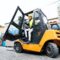 Female forklift truck driver outside a warehouse.